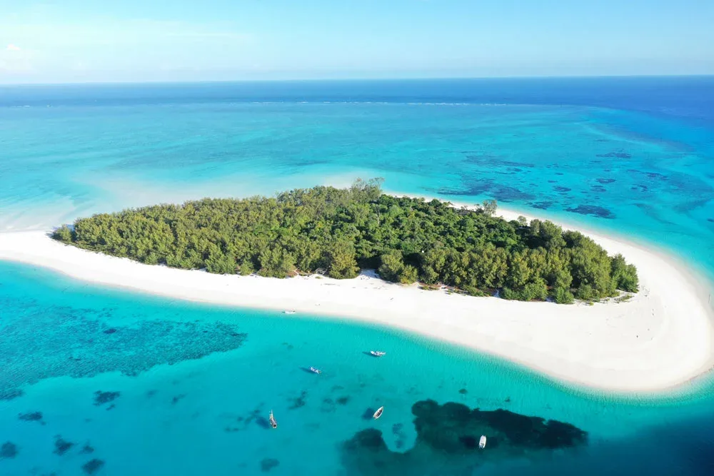 Pristine Zanzibar beach with turquoise waters, showcasing eco-friendly travel